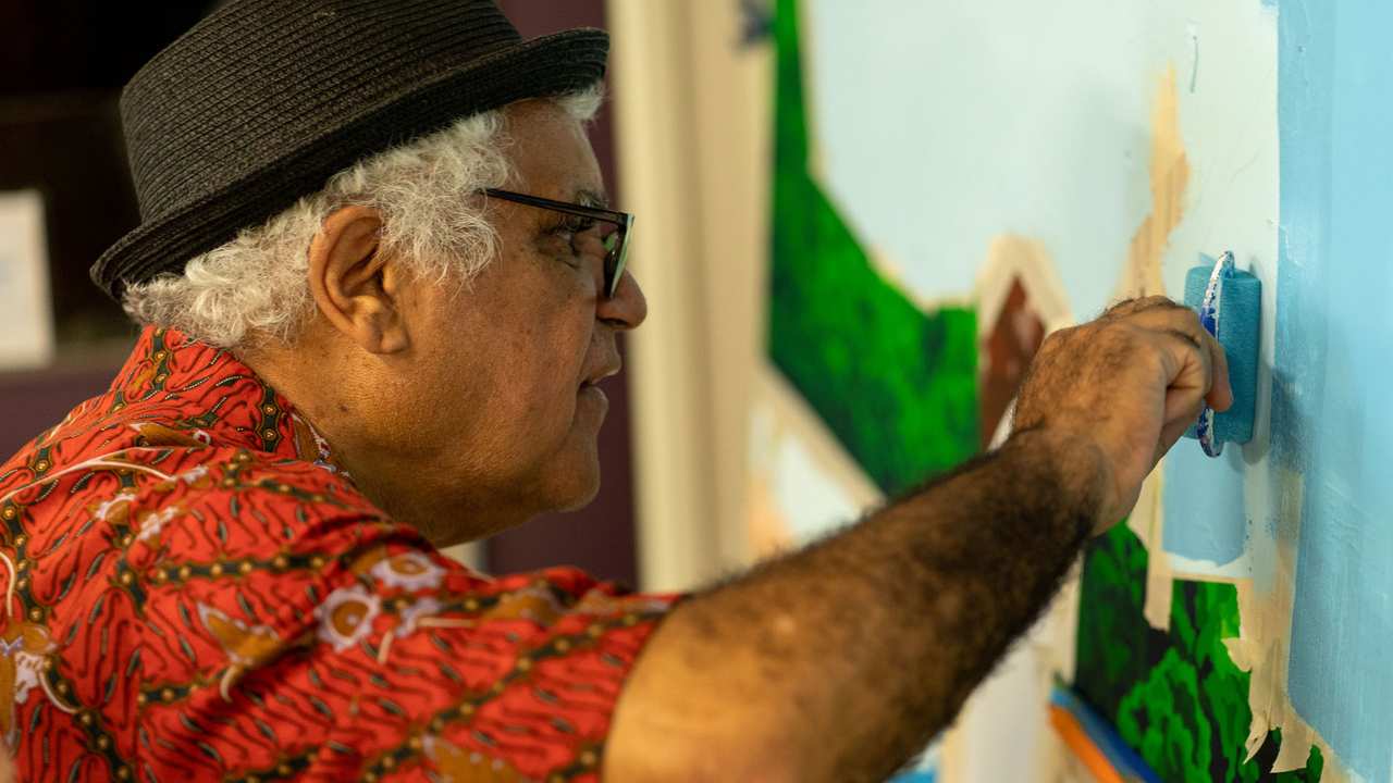a man with a hat and glasses  painting